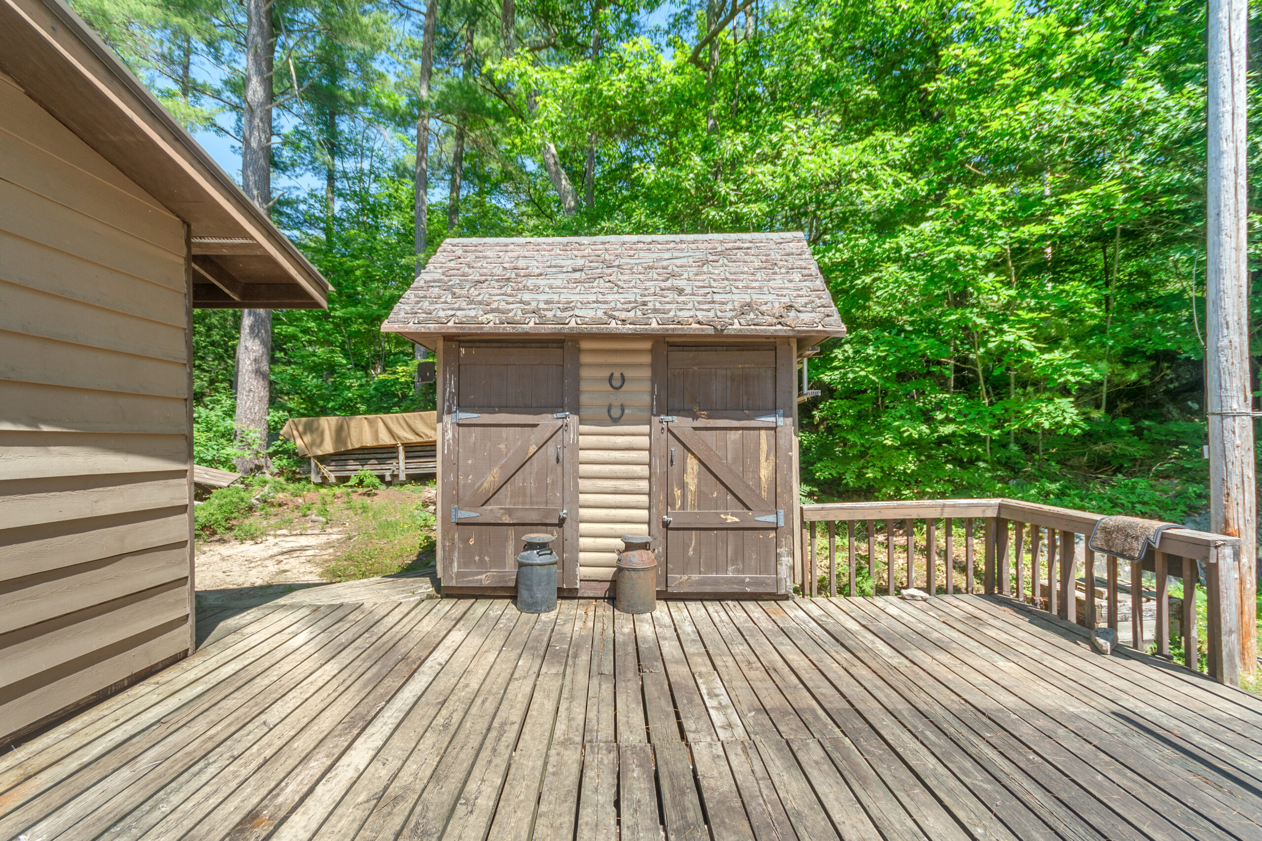 A wood shed on a wood deck