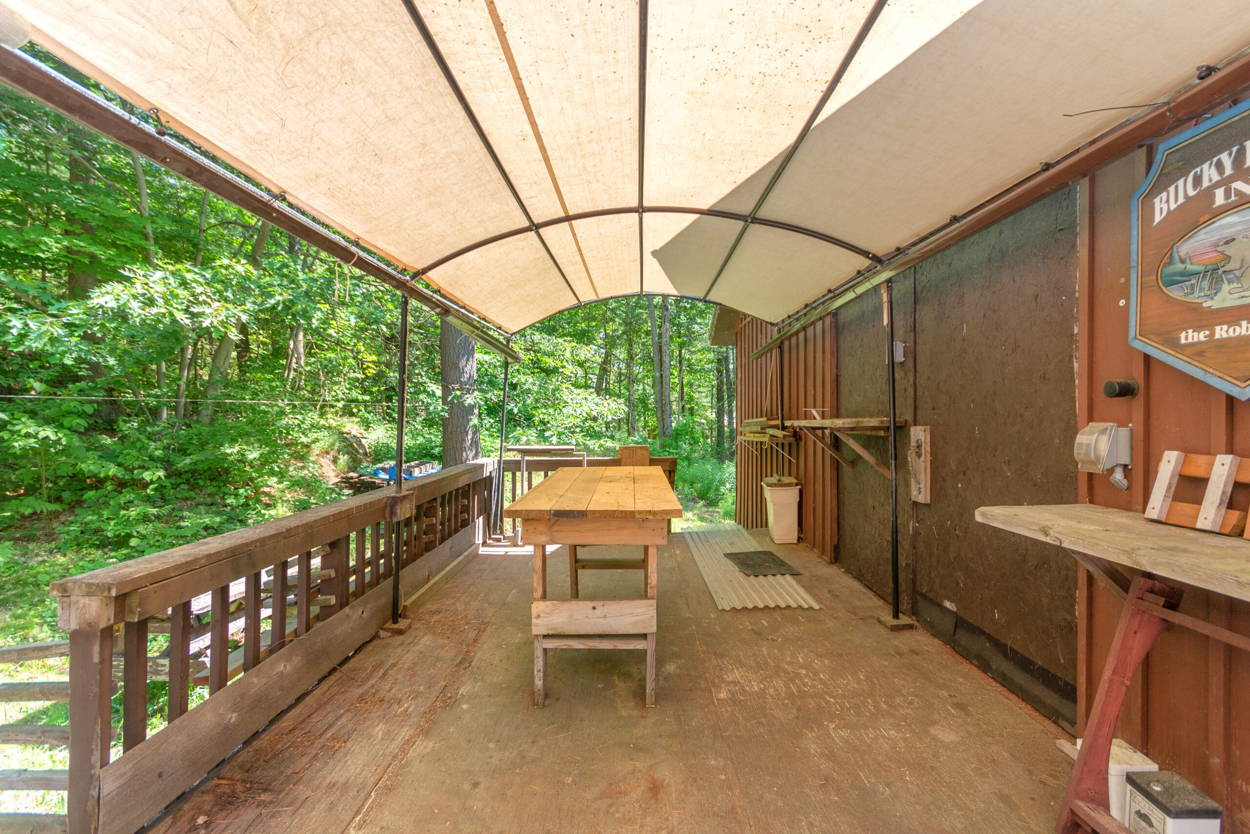 A wood table in a covered outdoor area