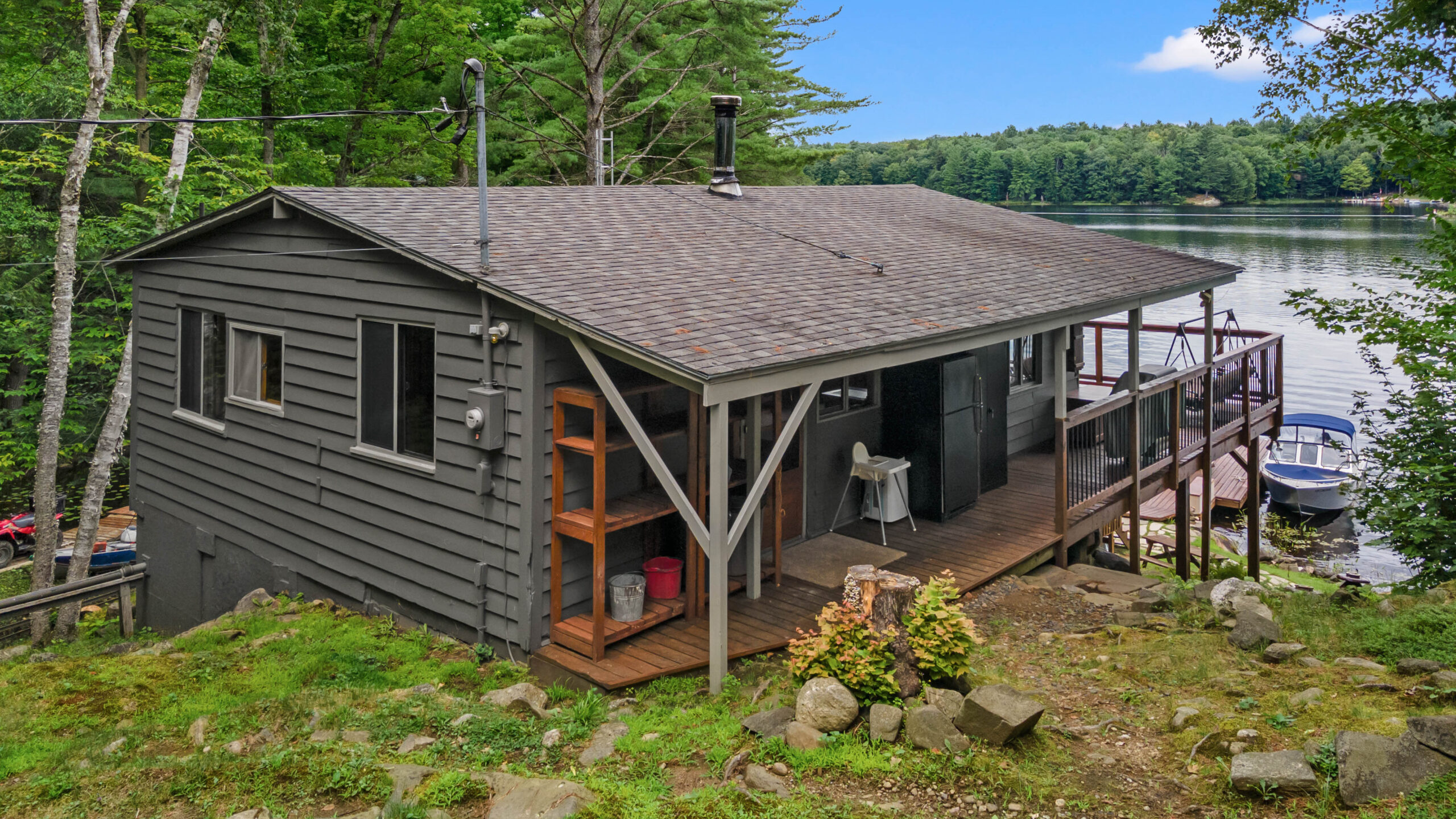A grey cottage entrance with a porch