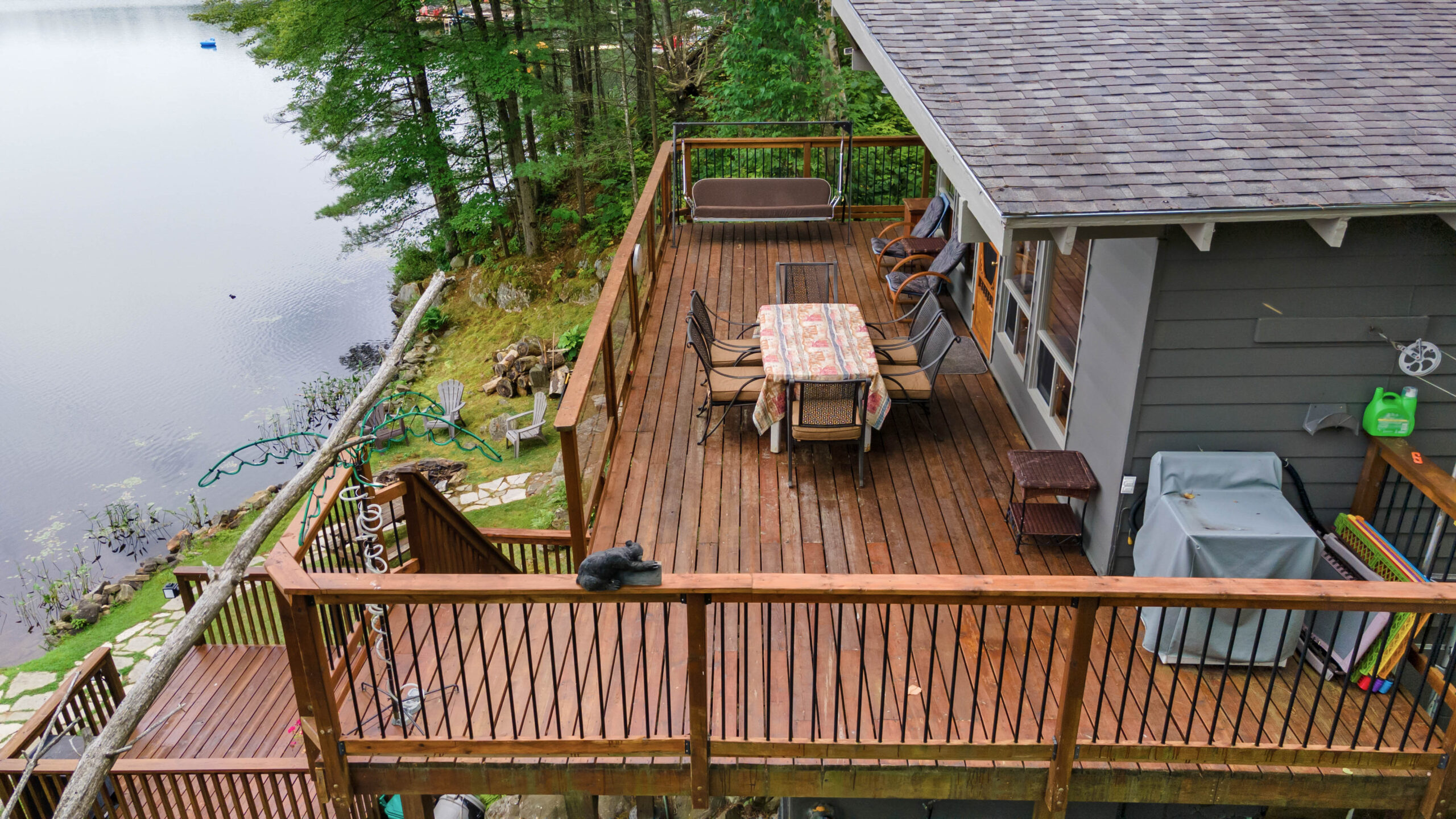 A dark brown deck with an outdoor dining area