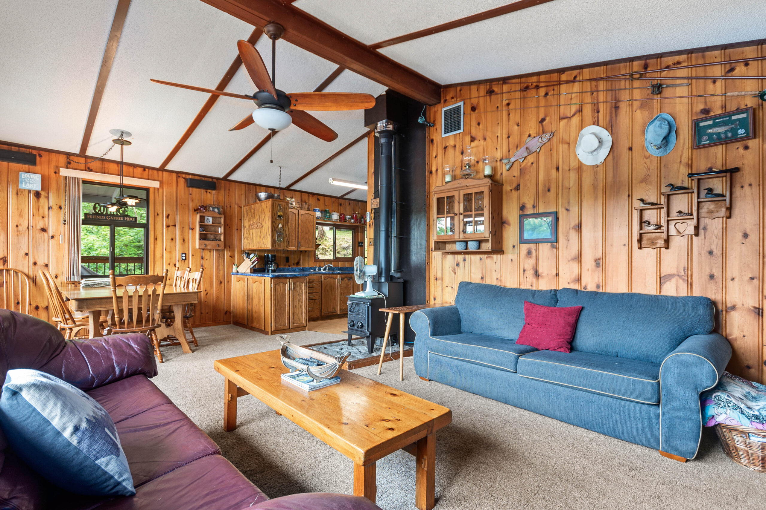 A blue couch faces a wood coffee table in a wood room
