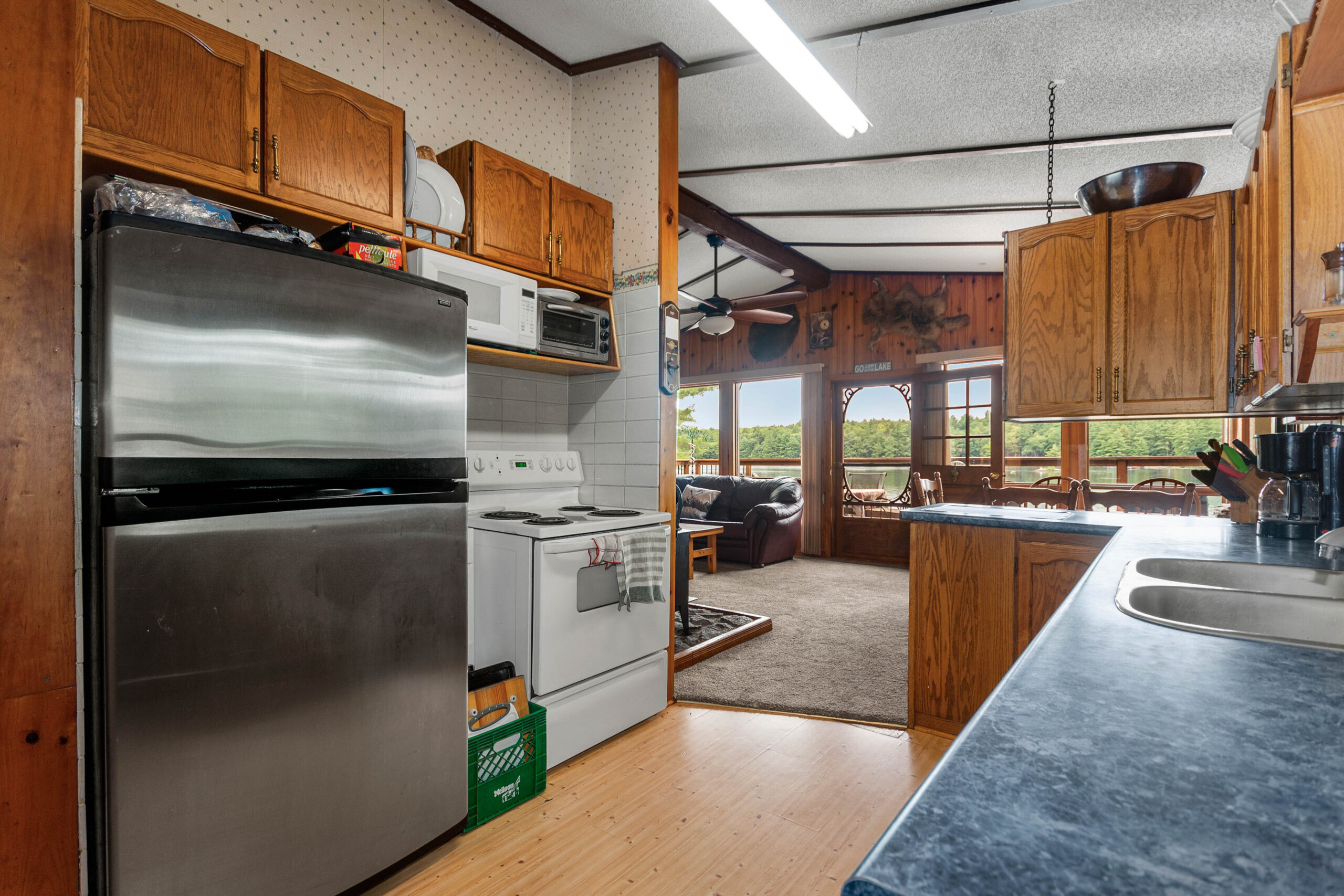 A stainless steel fridge in a wood kitchen