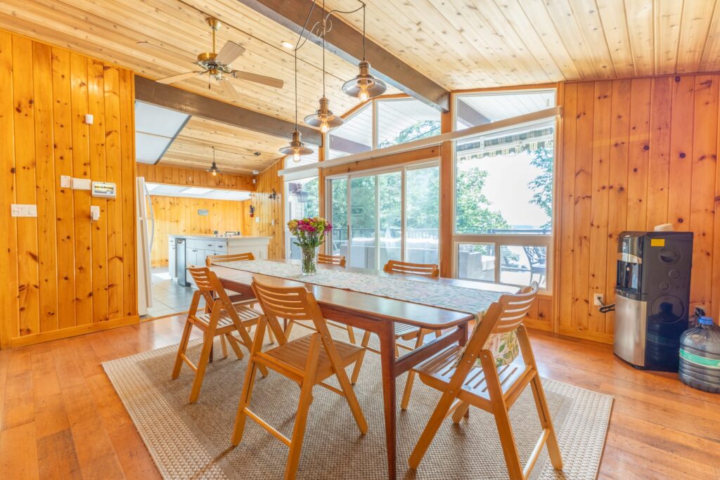 A wood dining table with wood chairs in a wood dining room