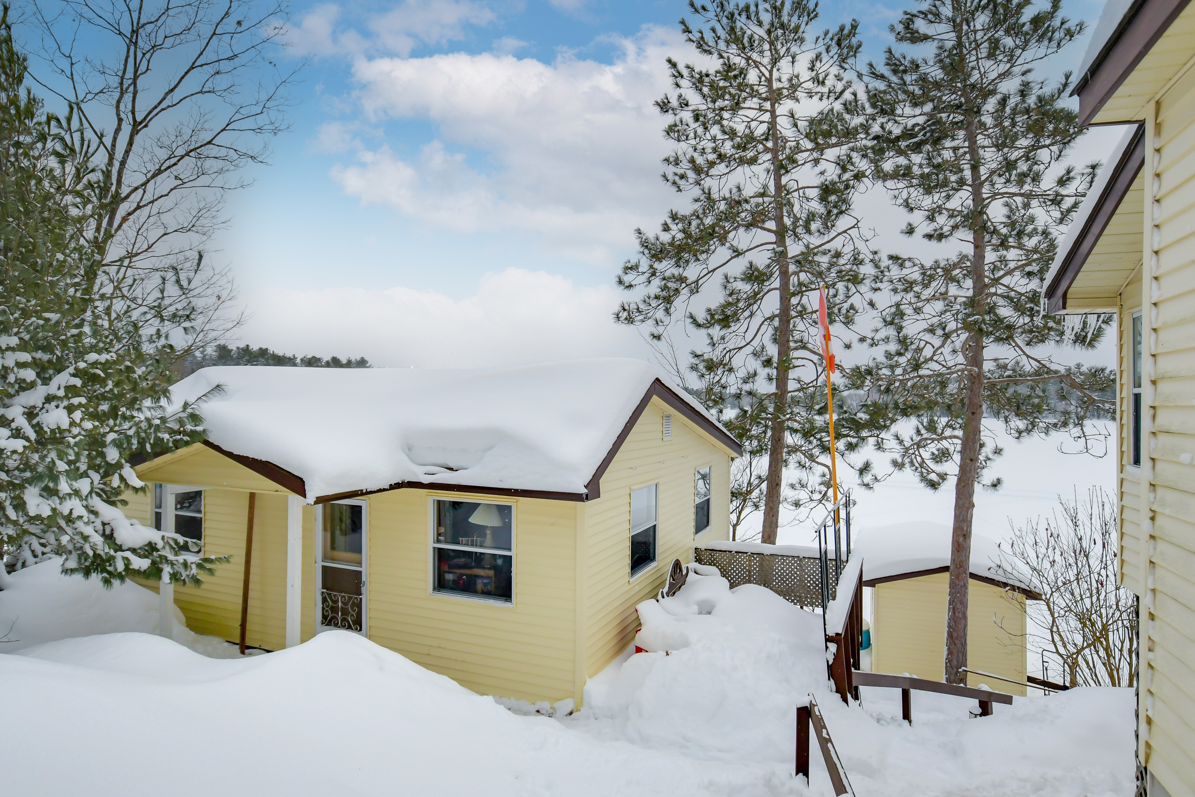 A charming secondary cottage on the property, nestled among trees and overlooking the lake, providing additional space for guests or rental opportunities.