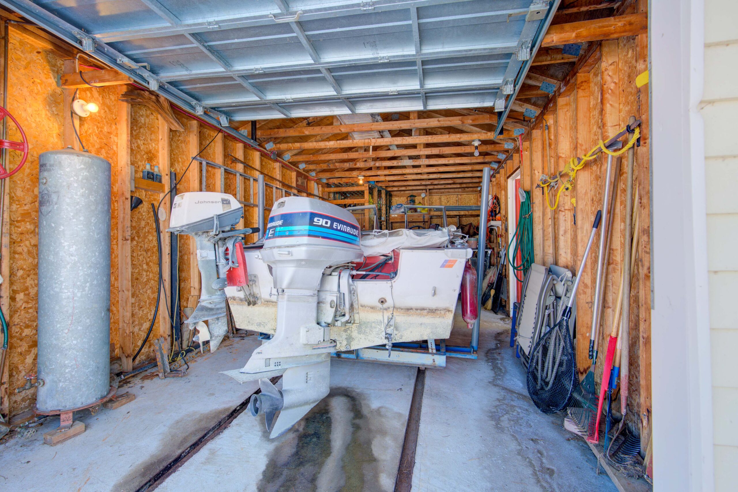 A boat is parked inside the unfinished boathouse