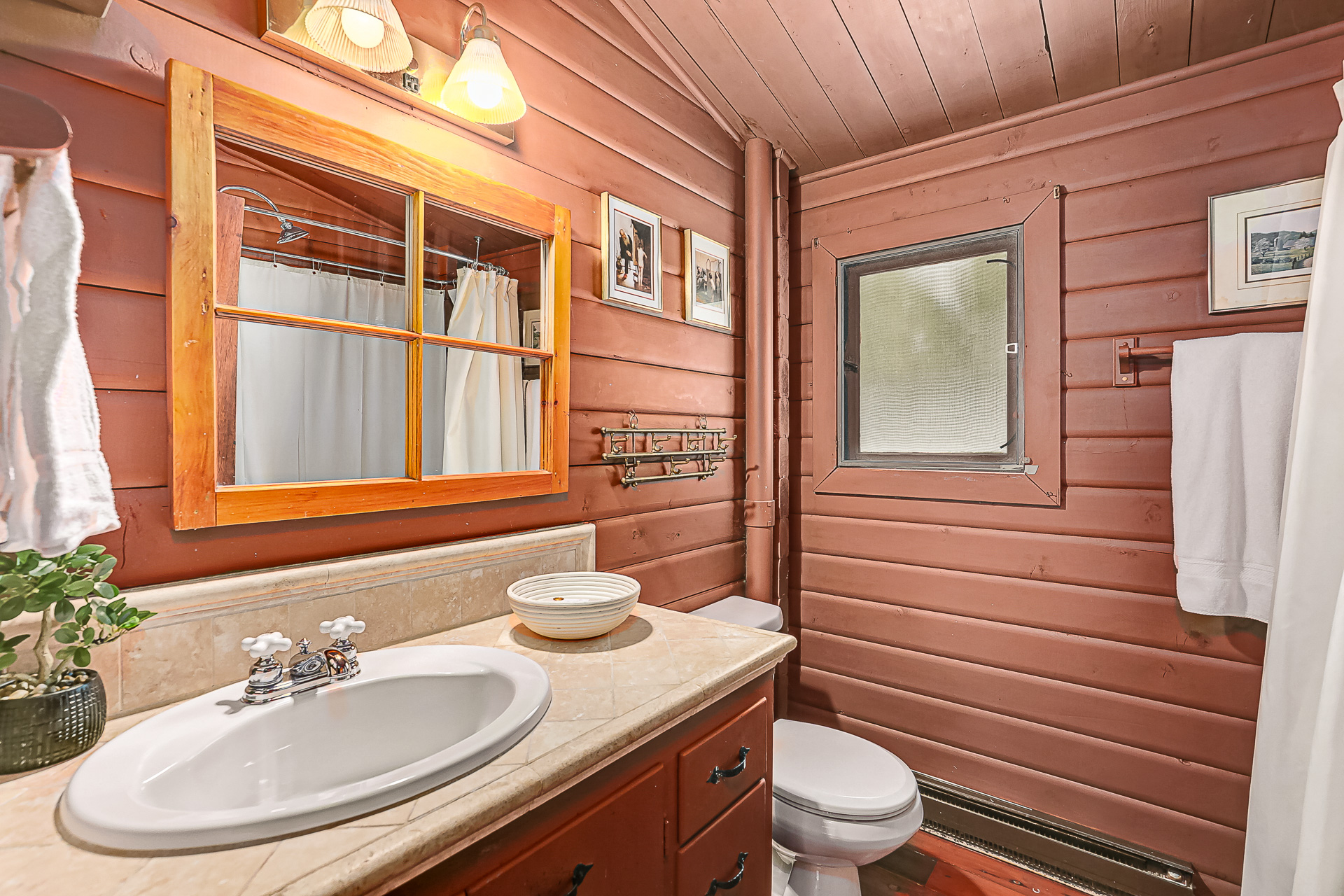 A wood bathroom vanity with white countertops