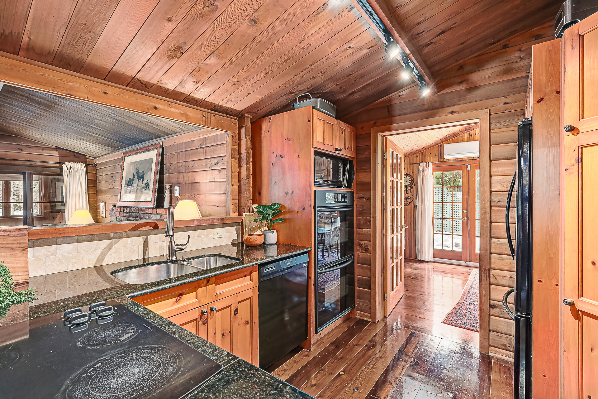 A wood kitchen with black countertops