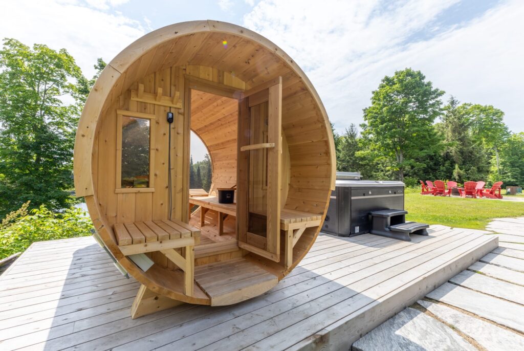 An open barrel sauna on a wood deck