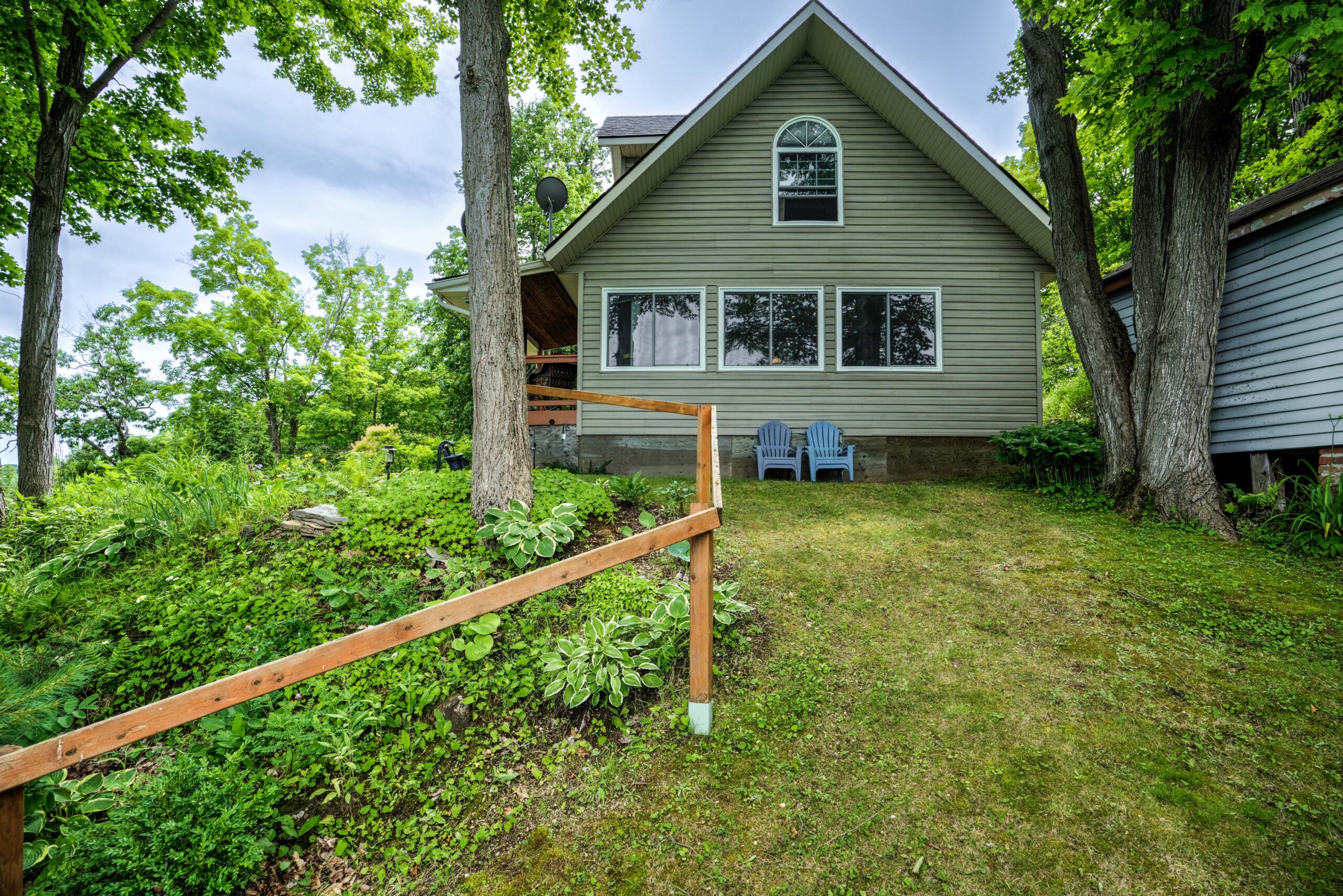A wood-paneled cottage with a brown rail
