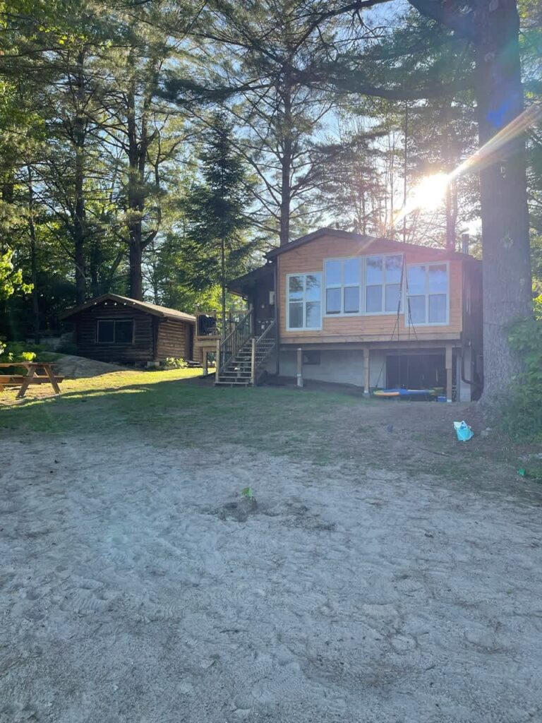 A cottage with a gravel driveway