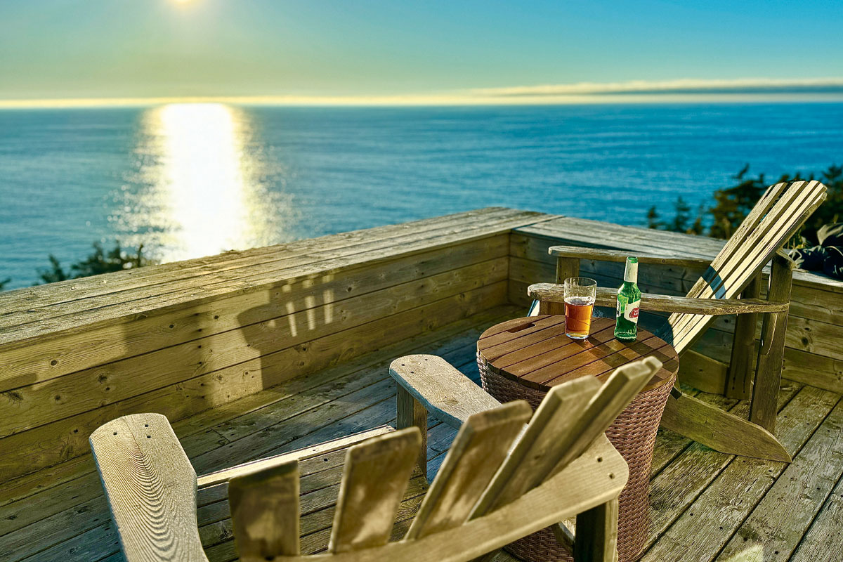 Two chairs on a patio overlooking the ocean