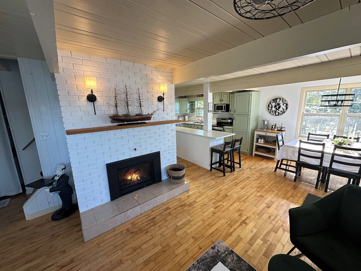 A white-washed fireplace in a white living room