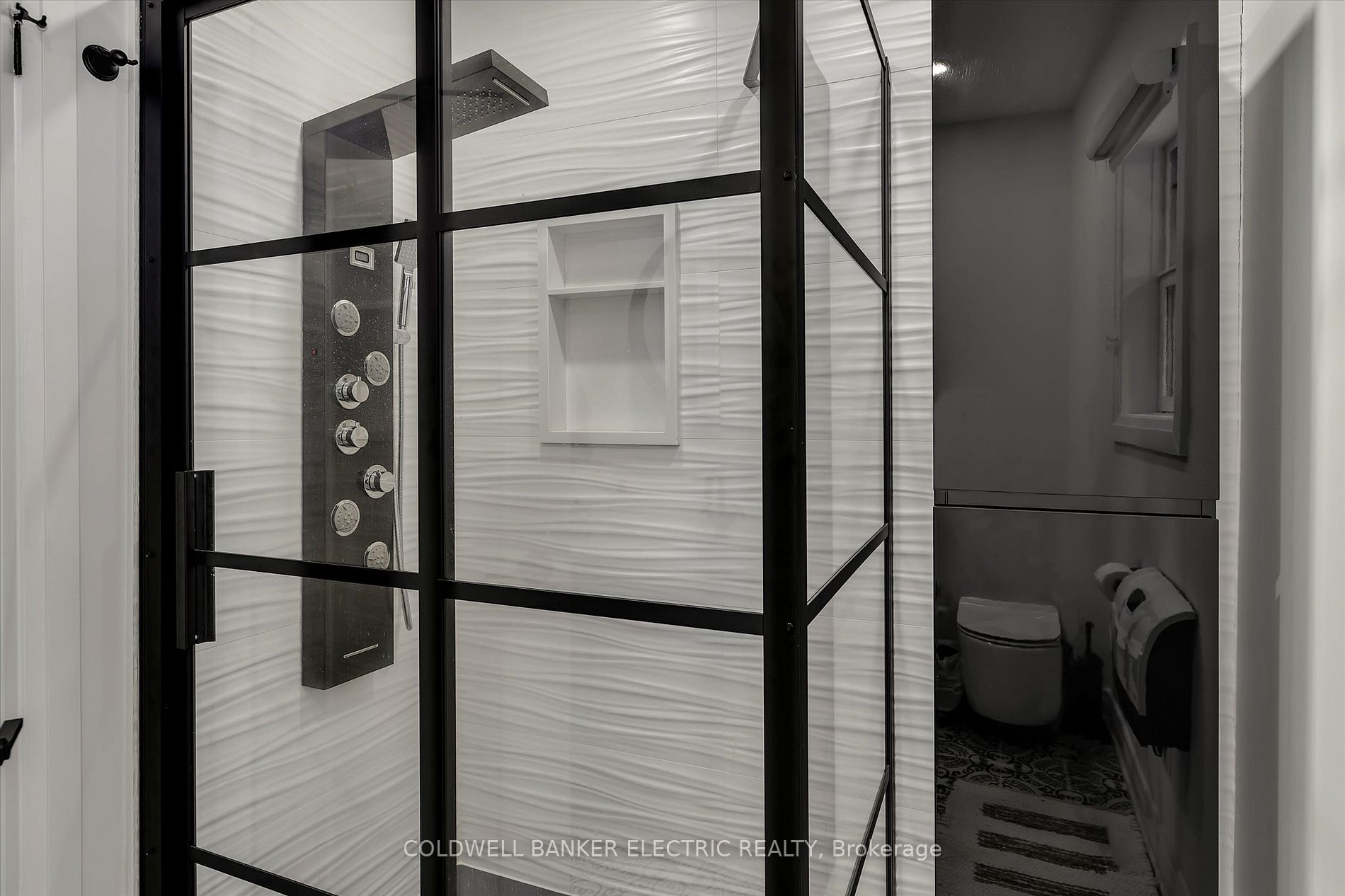 Stylish walk-in shower with black fixtures