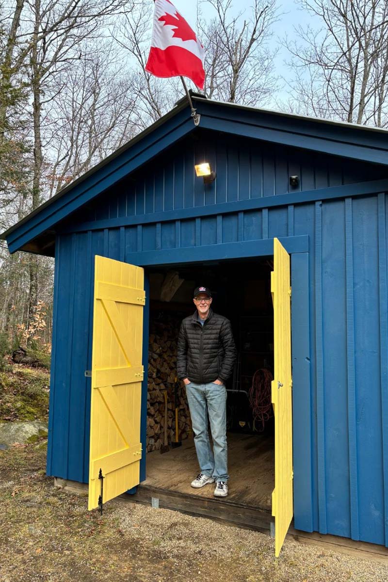 Man standing in a cottage shed