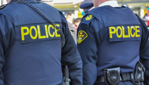 A view of two police officers from the back