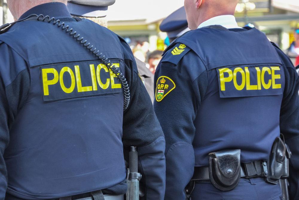 A view of two police officers from the back
