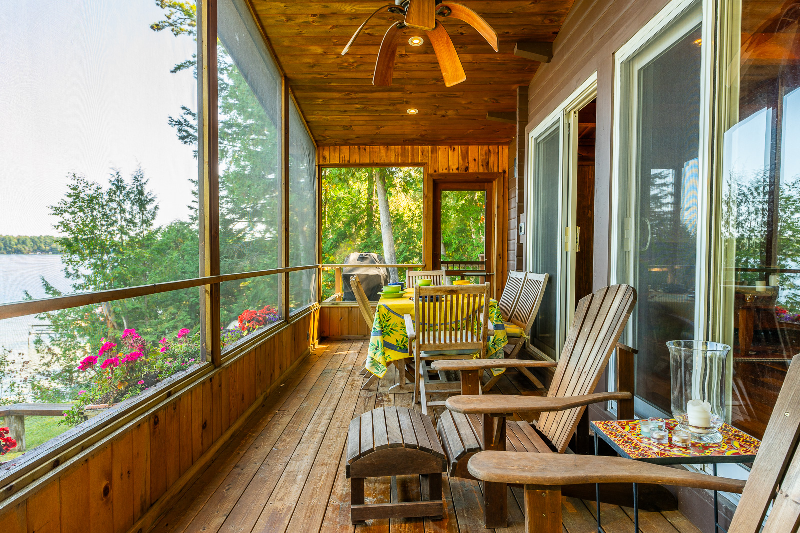 Wood Muskoka chairs face out to lake-facing windows