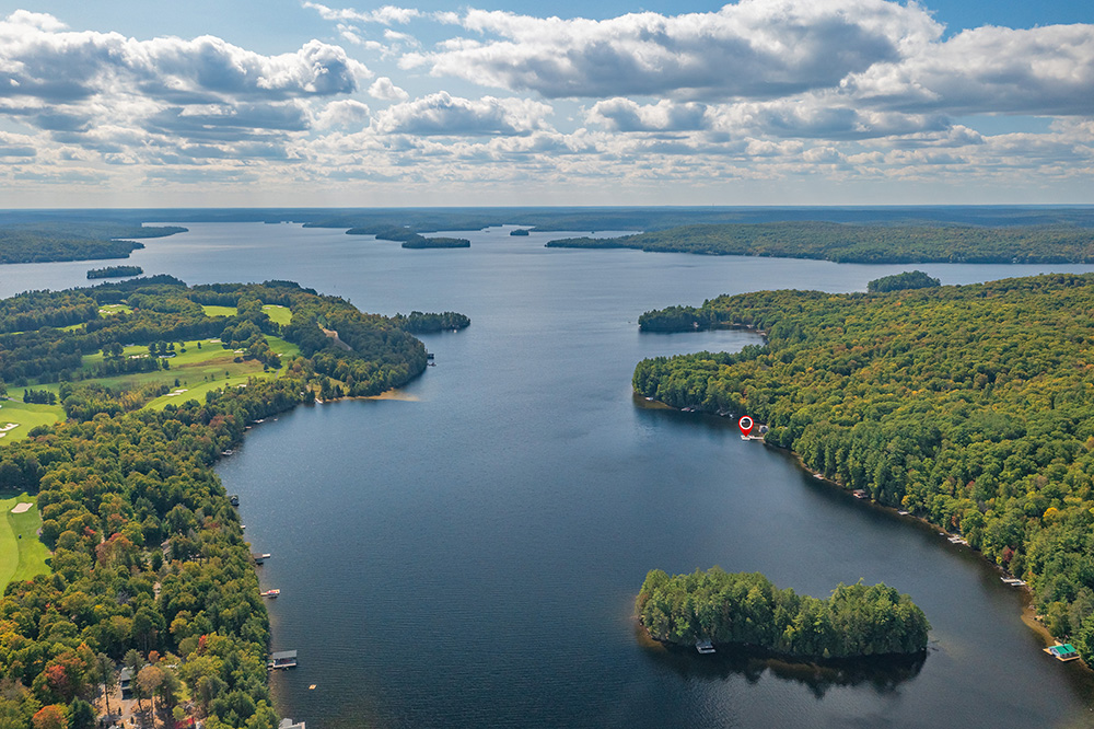 Wide aerial shot of Lake of Bays with islands, shoreline, and expansive forest
