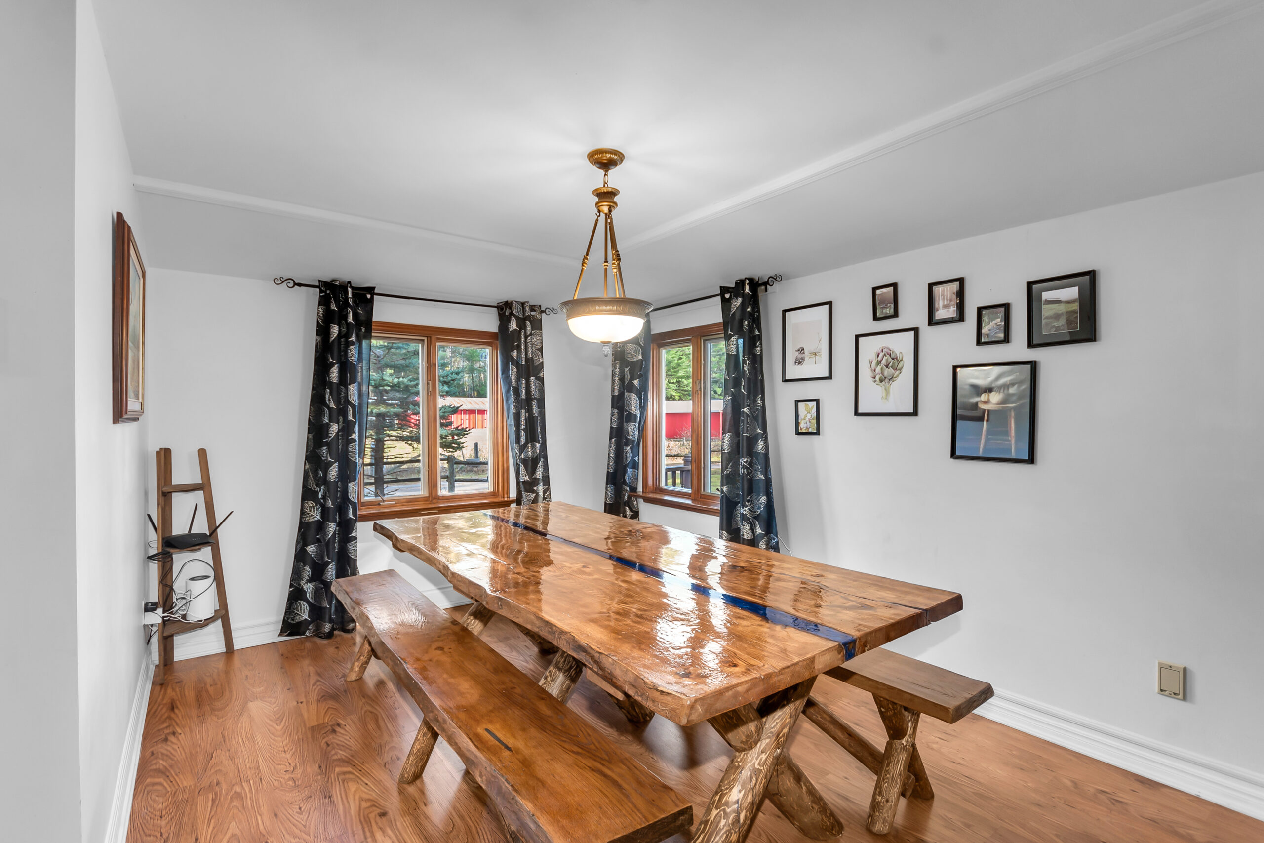 A wood table with wood benches in a white dining room