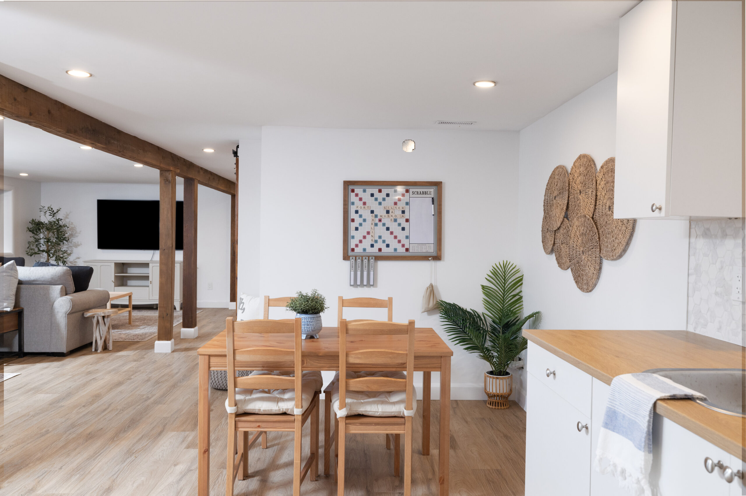 A wood table and chairs in a white basement