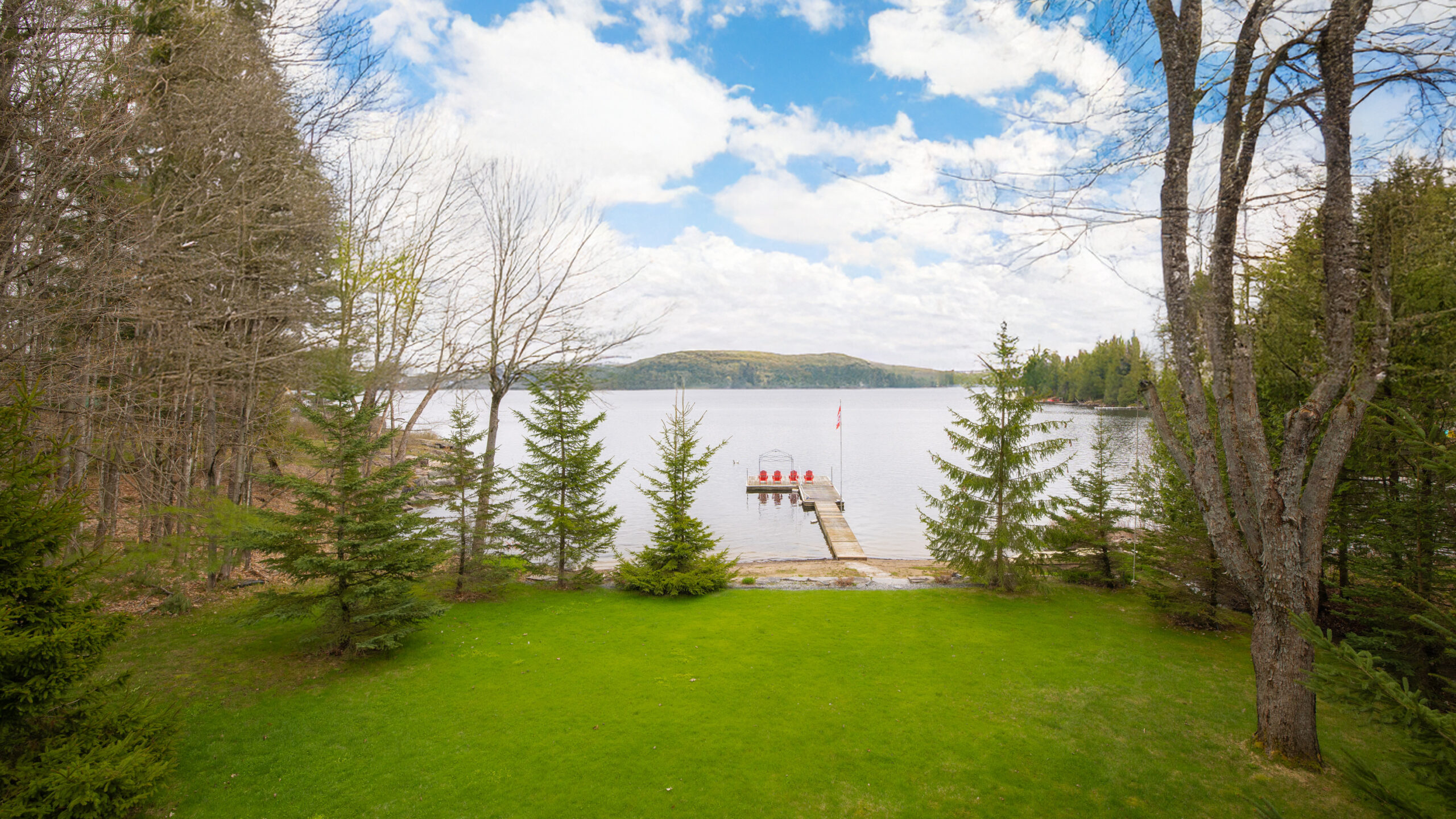 Shore of Three Mile Lake with a dock and trees.