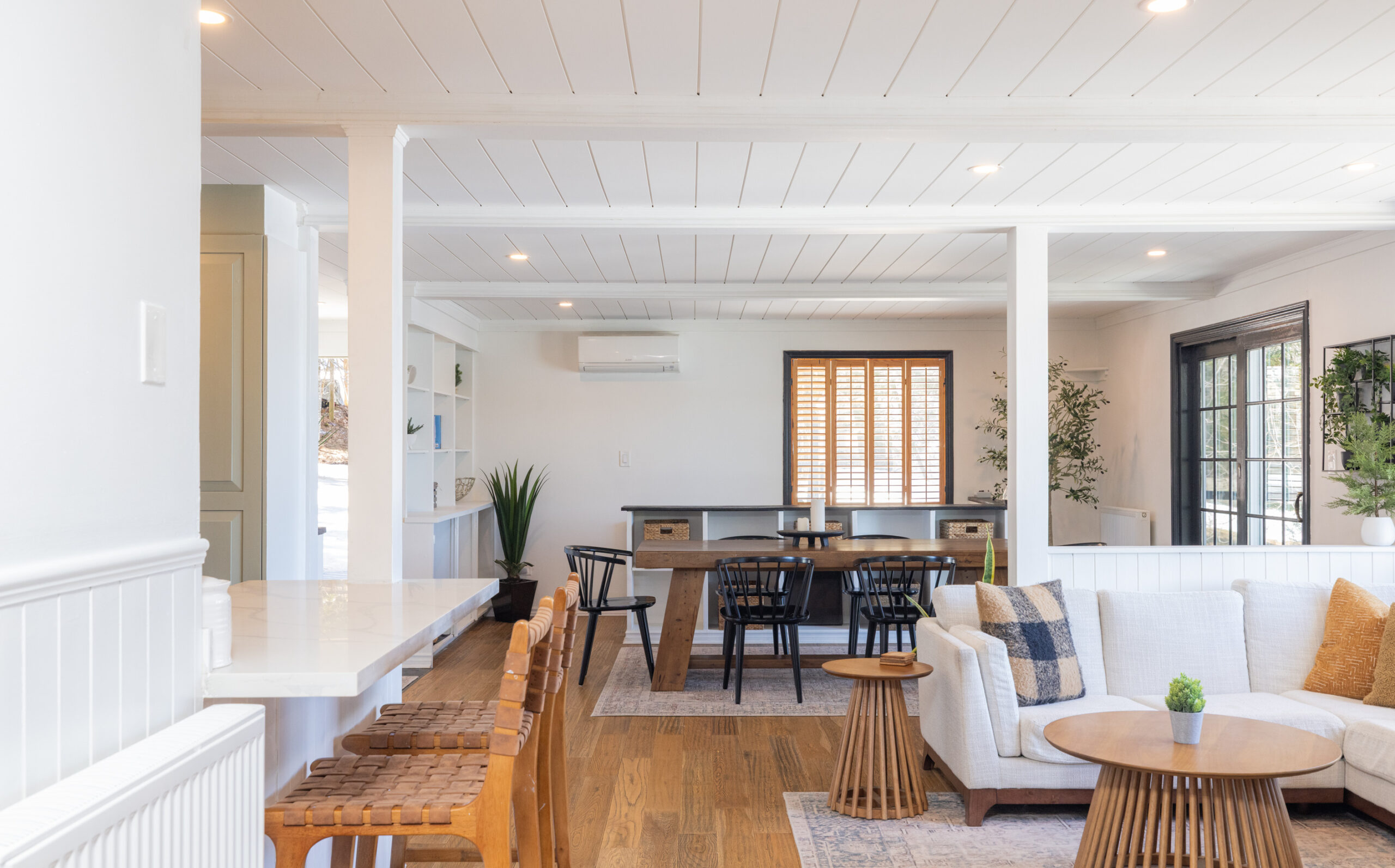 The kitchen seating area looks into a dining room with a wood table