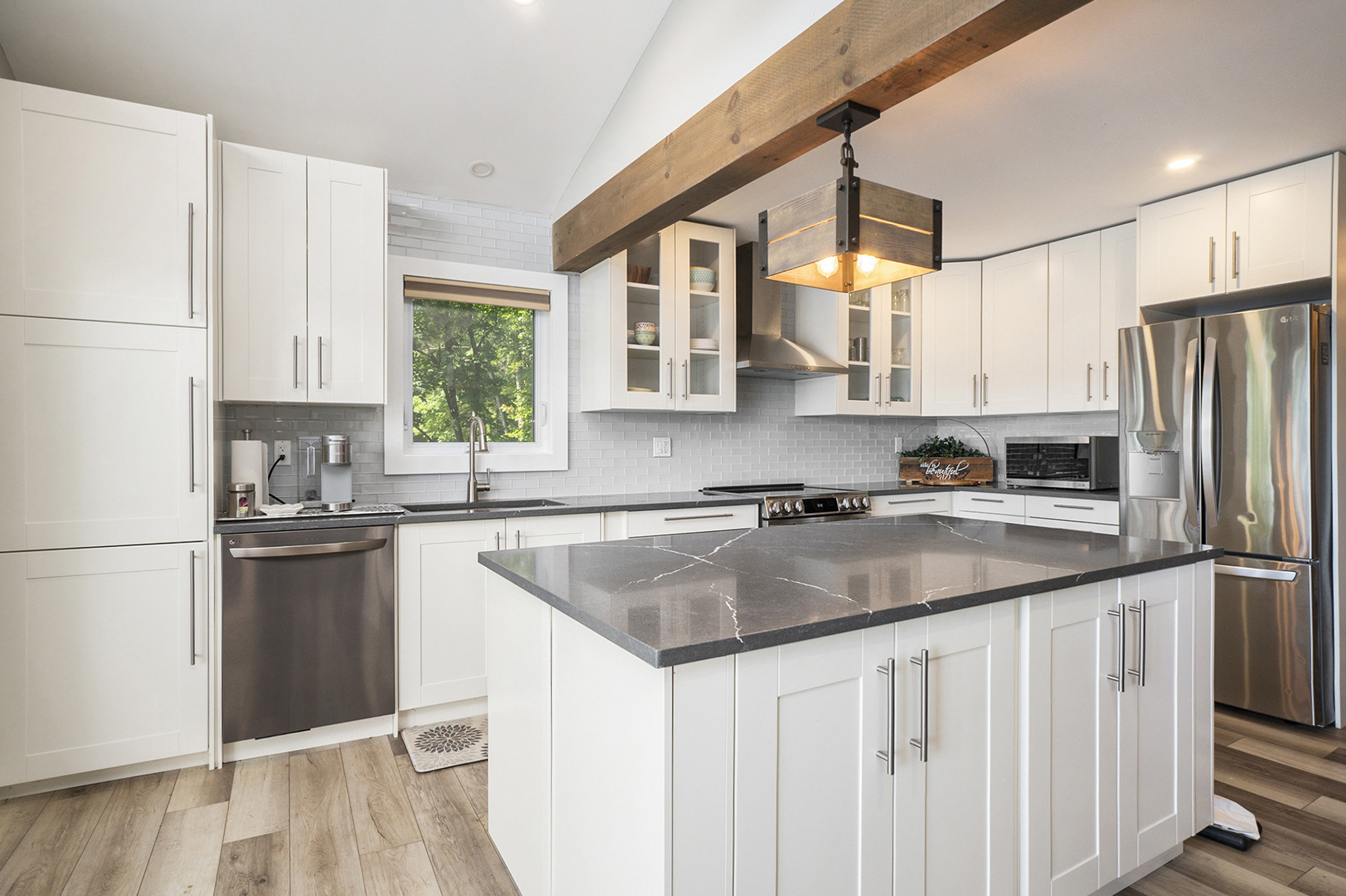 Contemporary kitchen design with island seating and elegant pendant lights under exposed beams