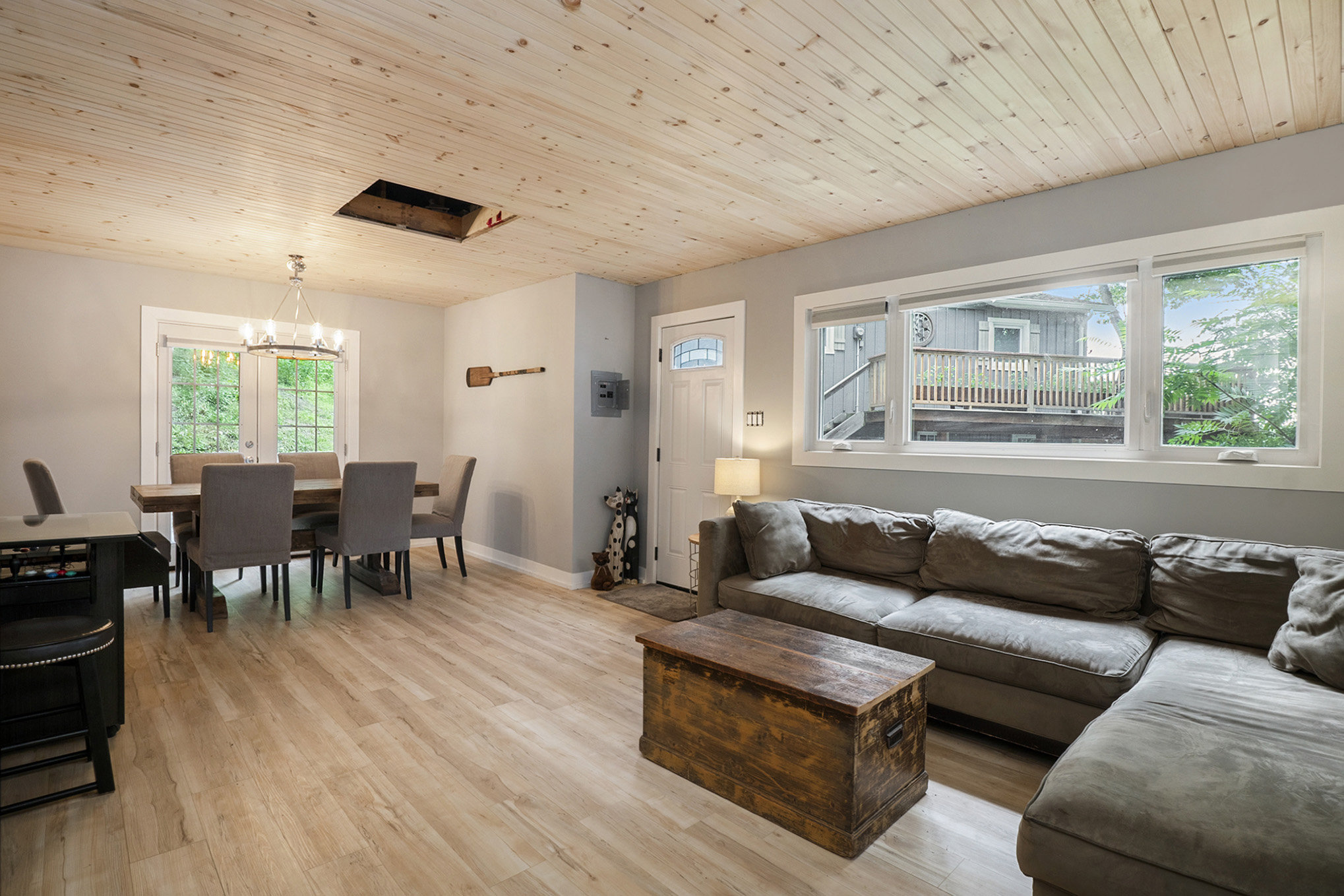 Expansive family room with sectional seating, wood floors, and a view to the outdoors