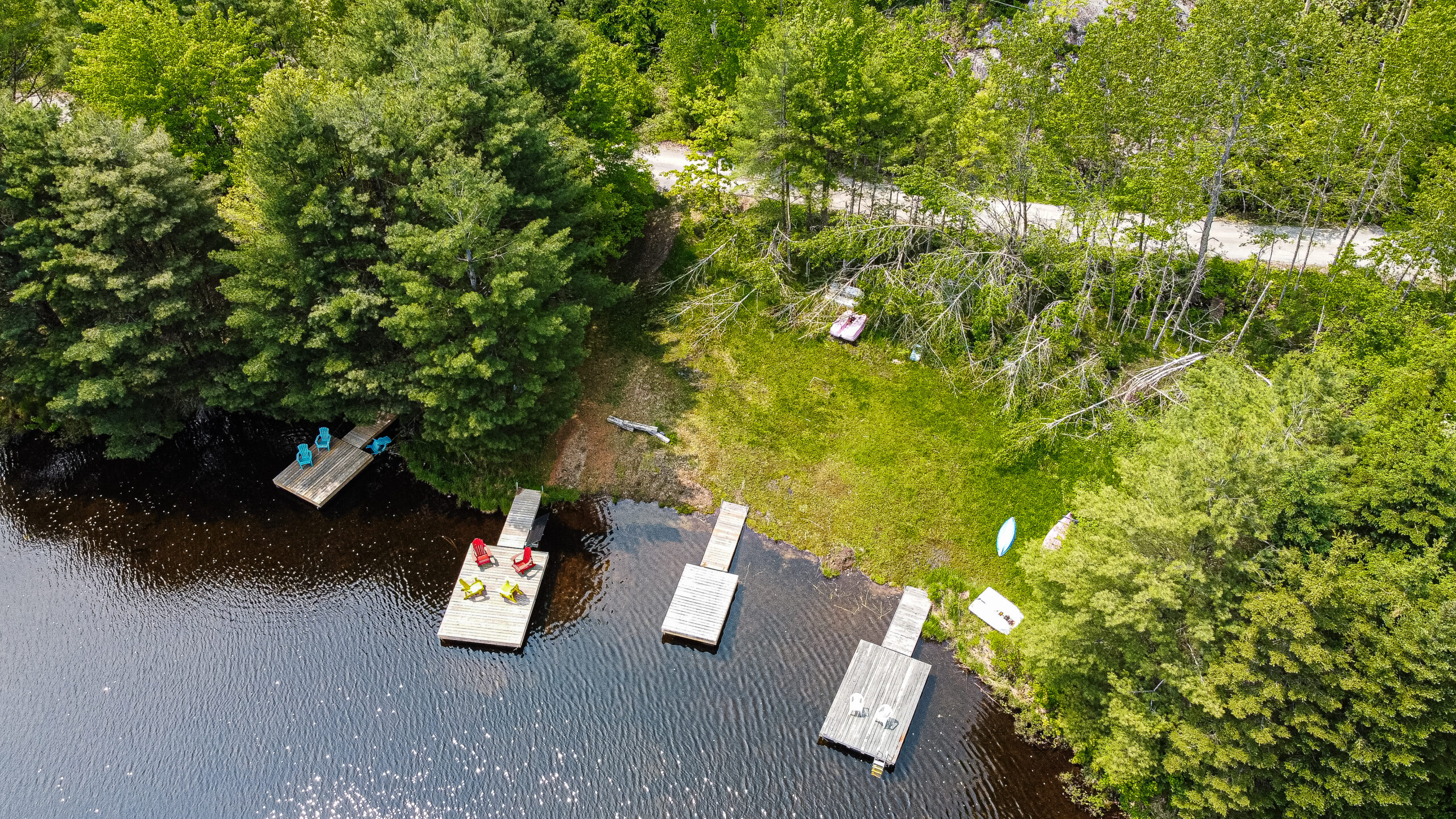 Three docks just out from the forest into the lake