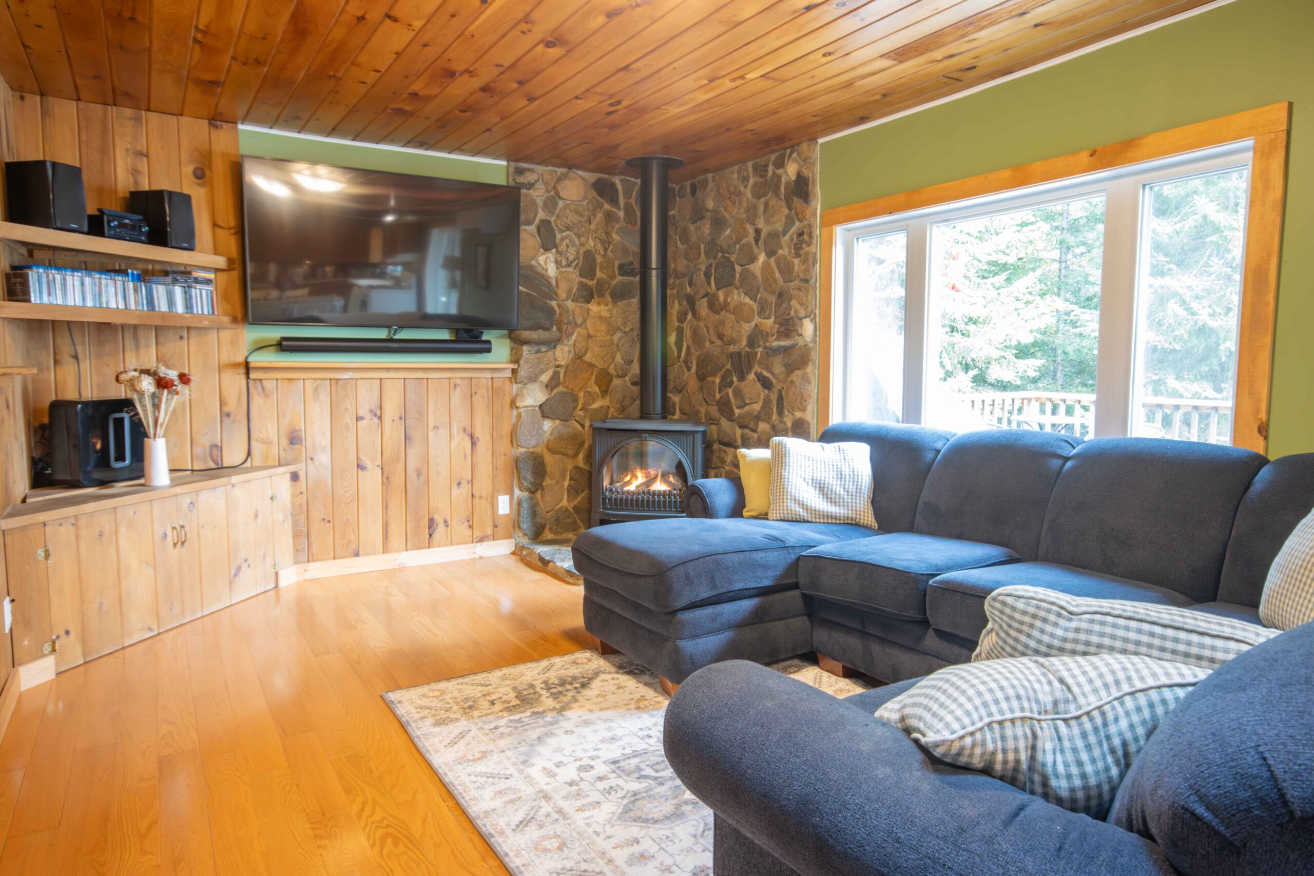 Warm and inviting living space with a sectional couch and wood finishes.