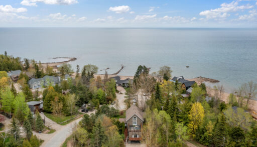 Aerial view of a brown wood-paneled cottage down the street from Georgian Bay