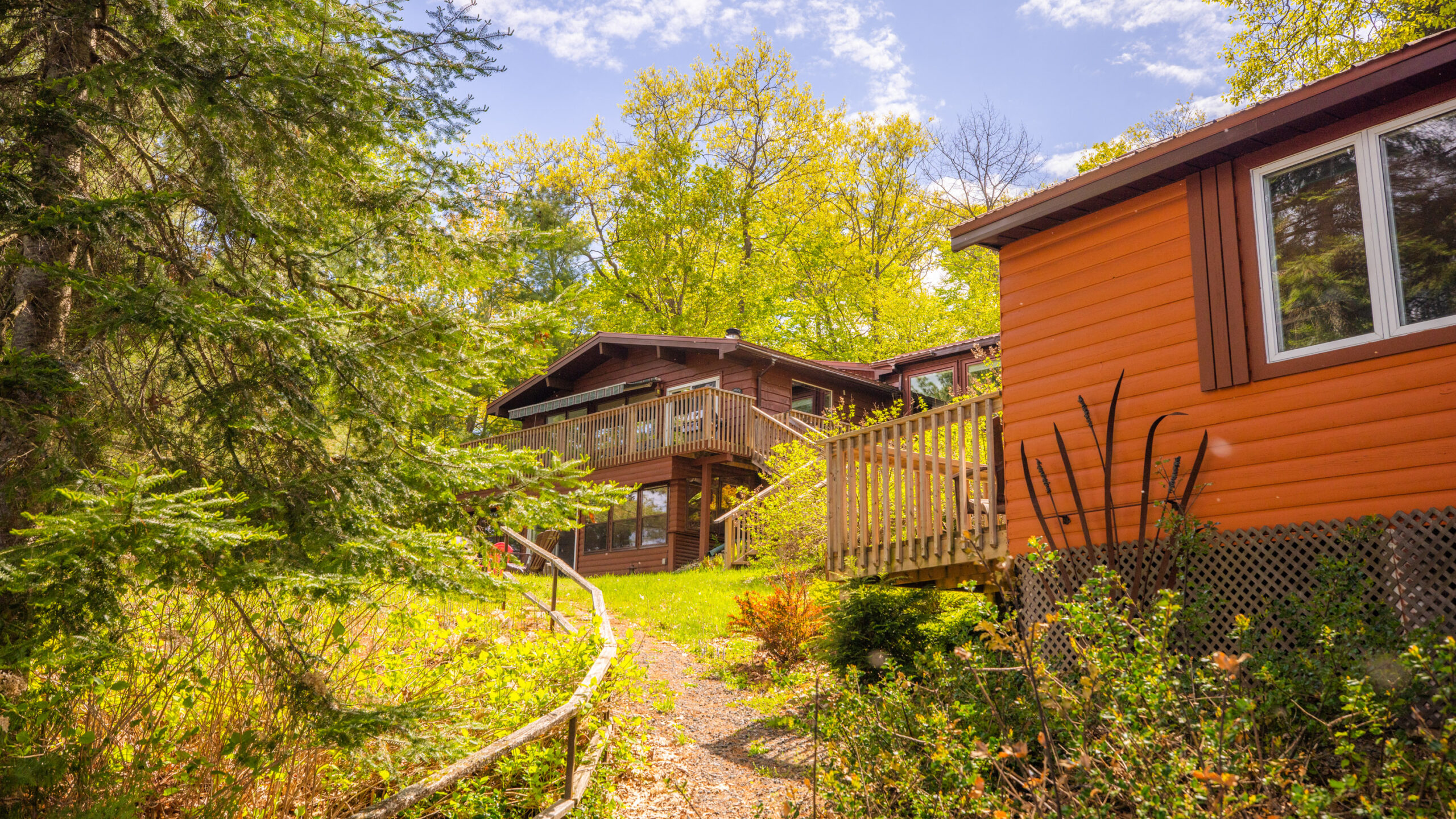 A path leads down back the big cottage and bunkie