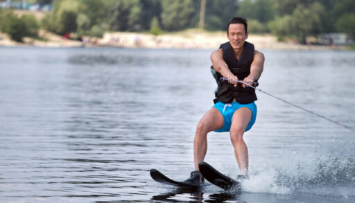A man on waterskis being towed by a line