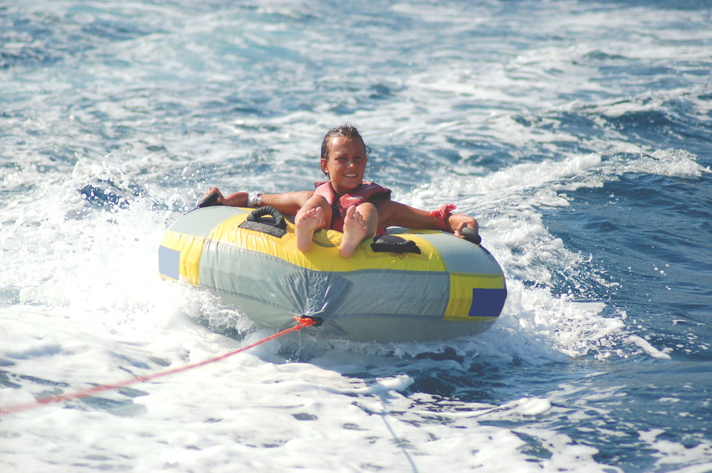 A girl being towed on a tube
