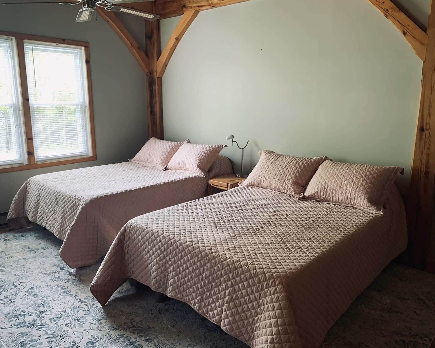 Two beds with light pink bedspreads