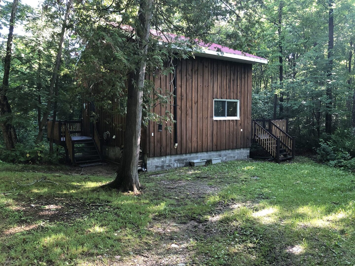 A small wood cabin surrounded by trees