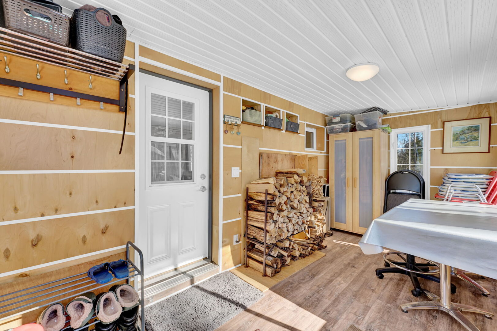 A white door leads to a wood-paneled sunrom