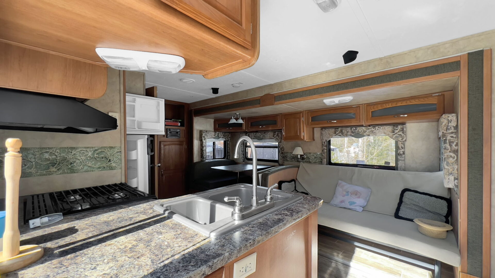 A dark wood and grey stone mobile home living area