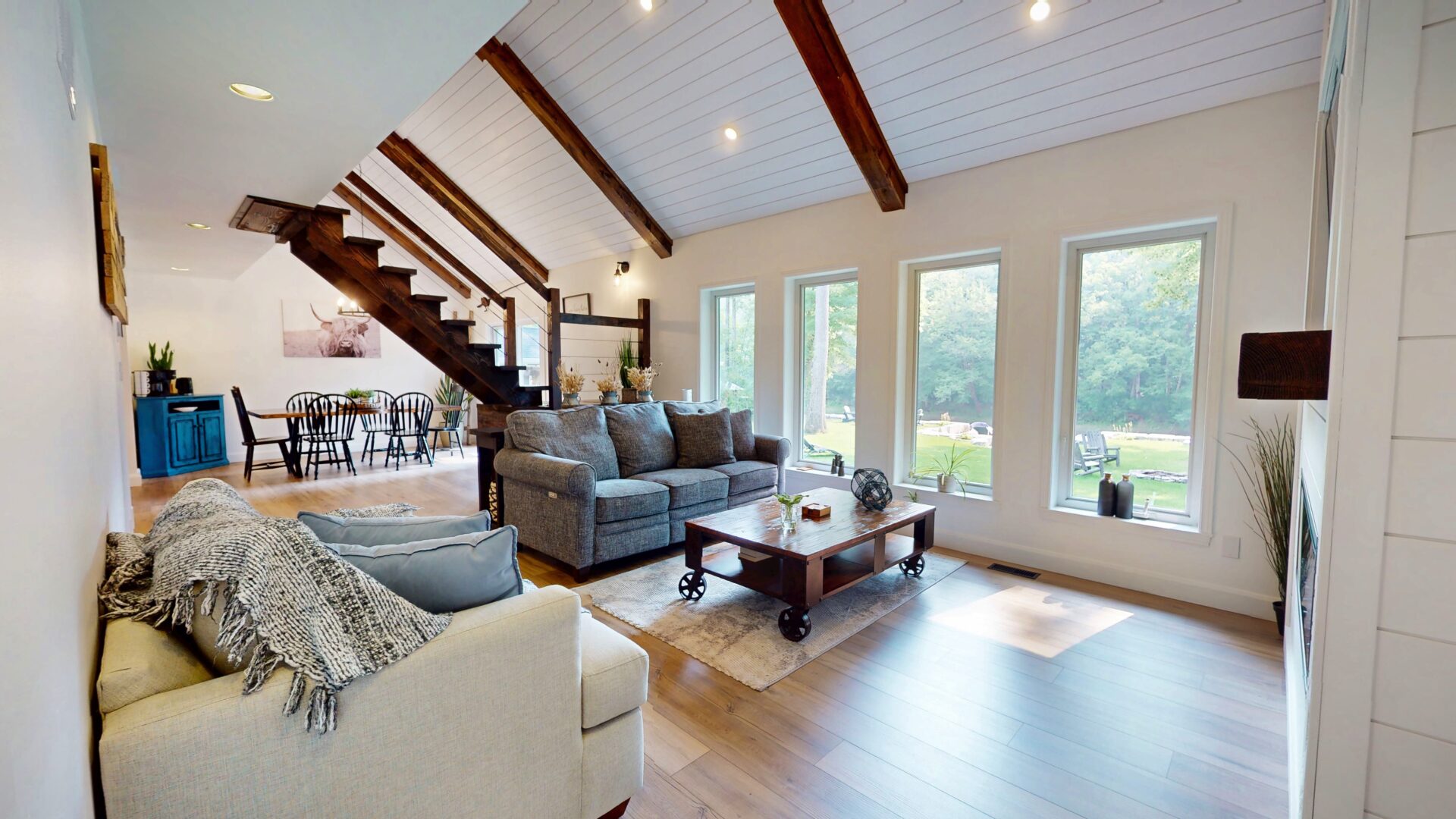A white living room with large windows