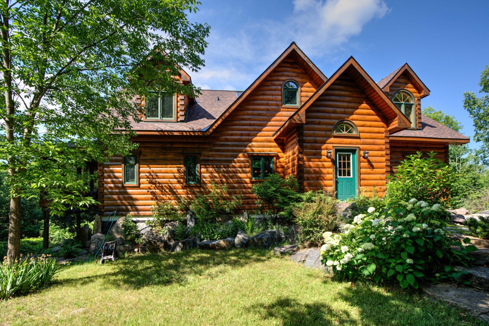 A log cabin with a green door