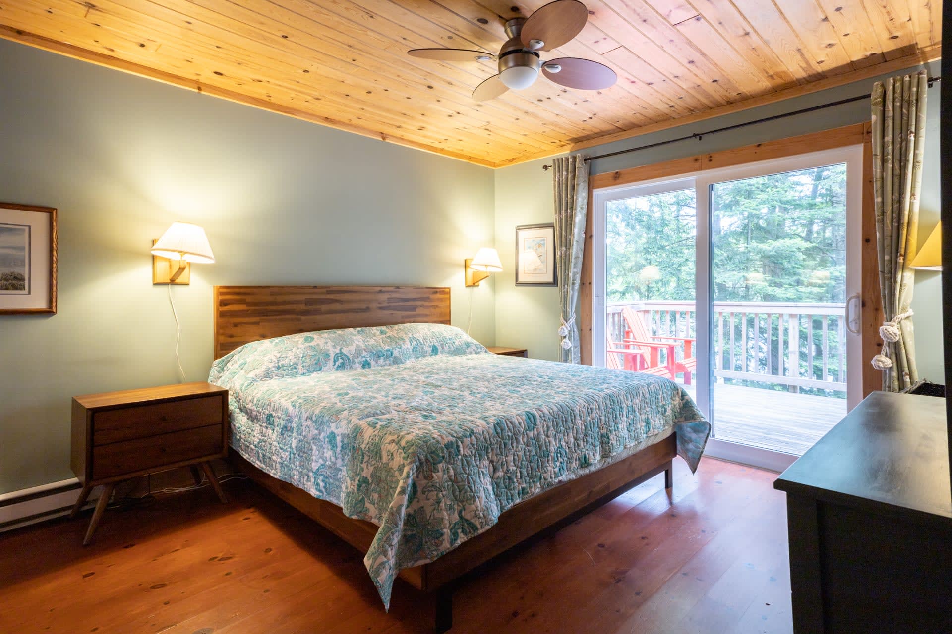 A bed with a floral bed in a light blue room