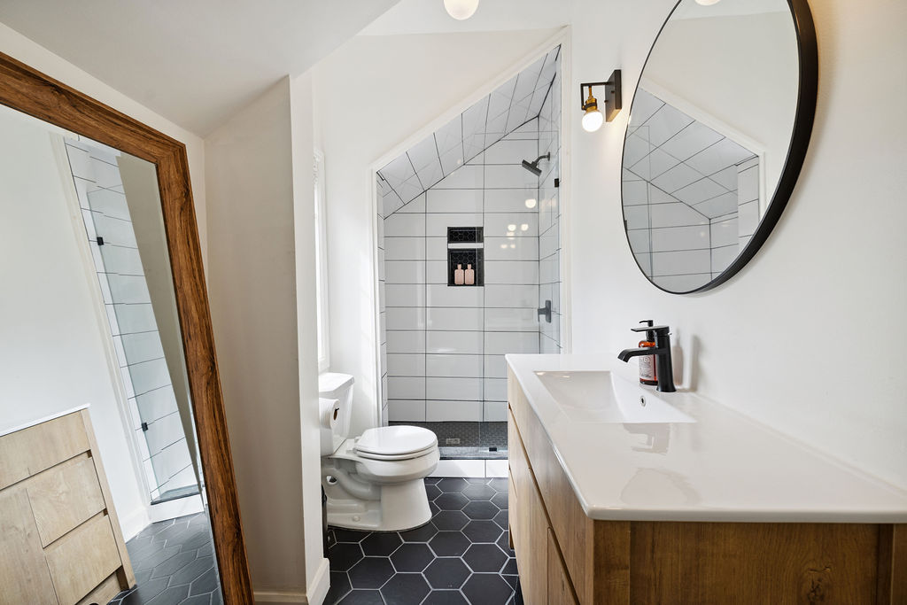 A white bathroom with blue floor tiles
