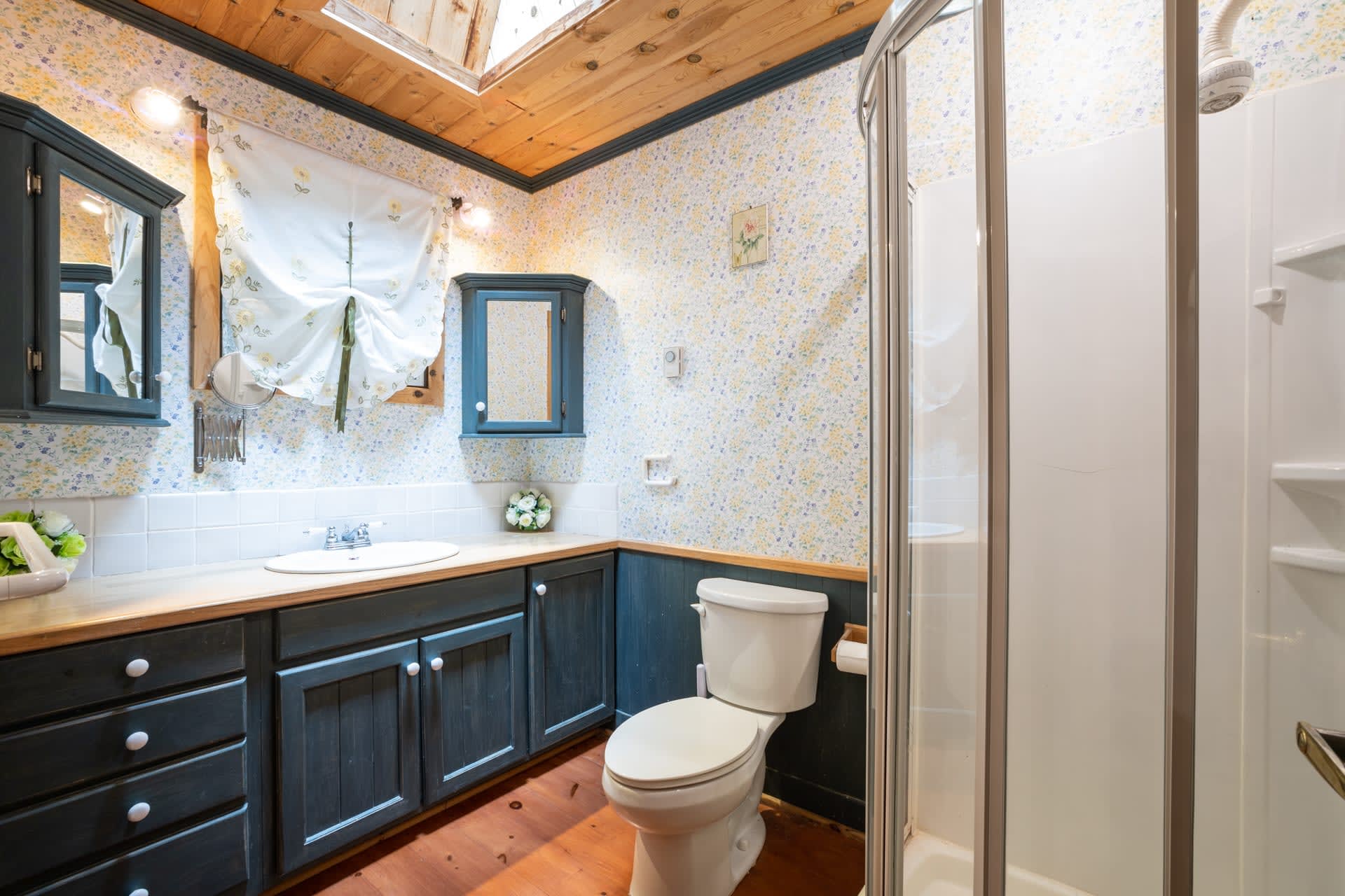 A white bathroom with a blue vanity
