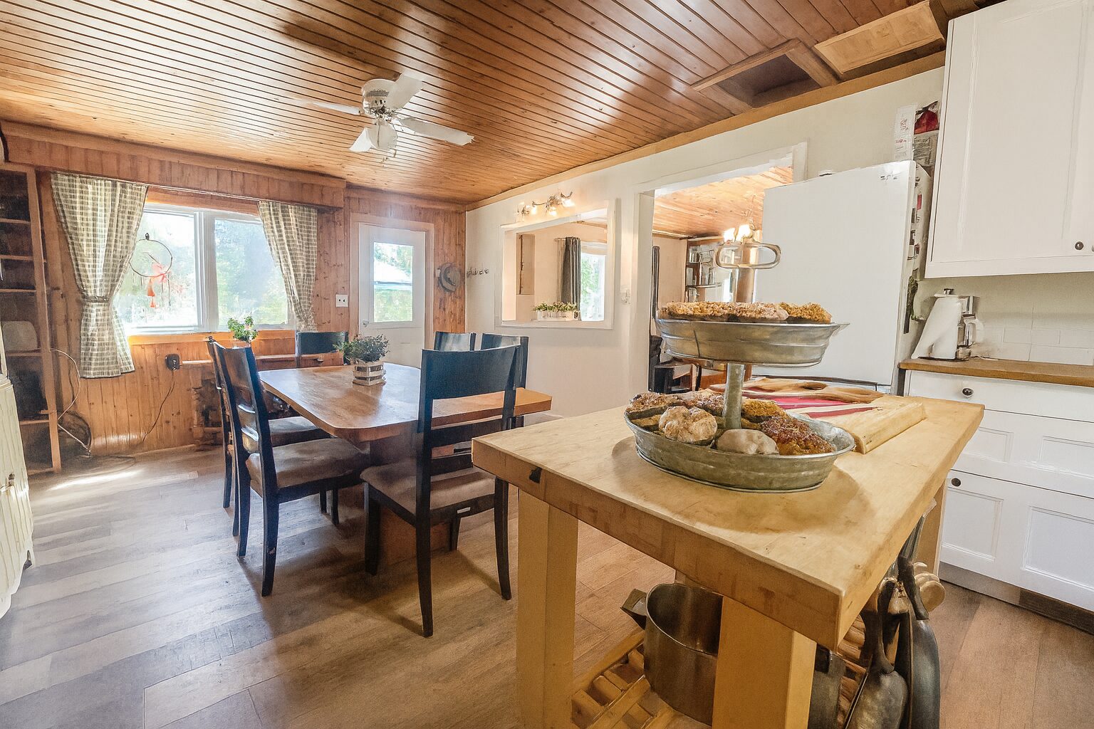 A wood island faces a wood dining table