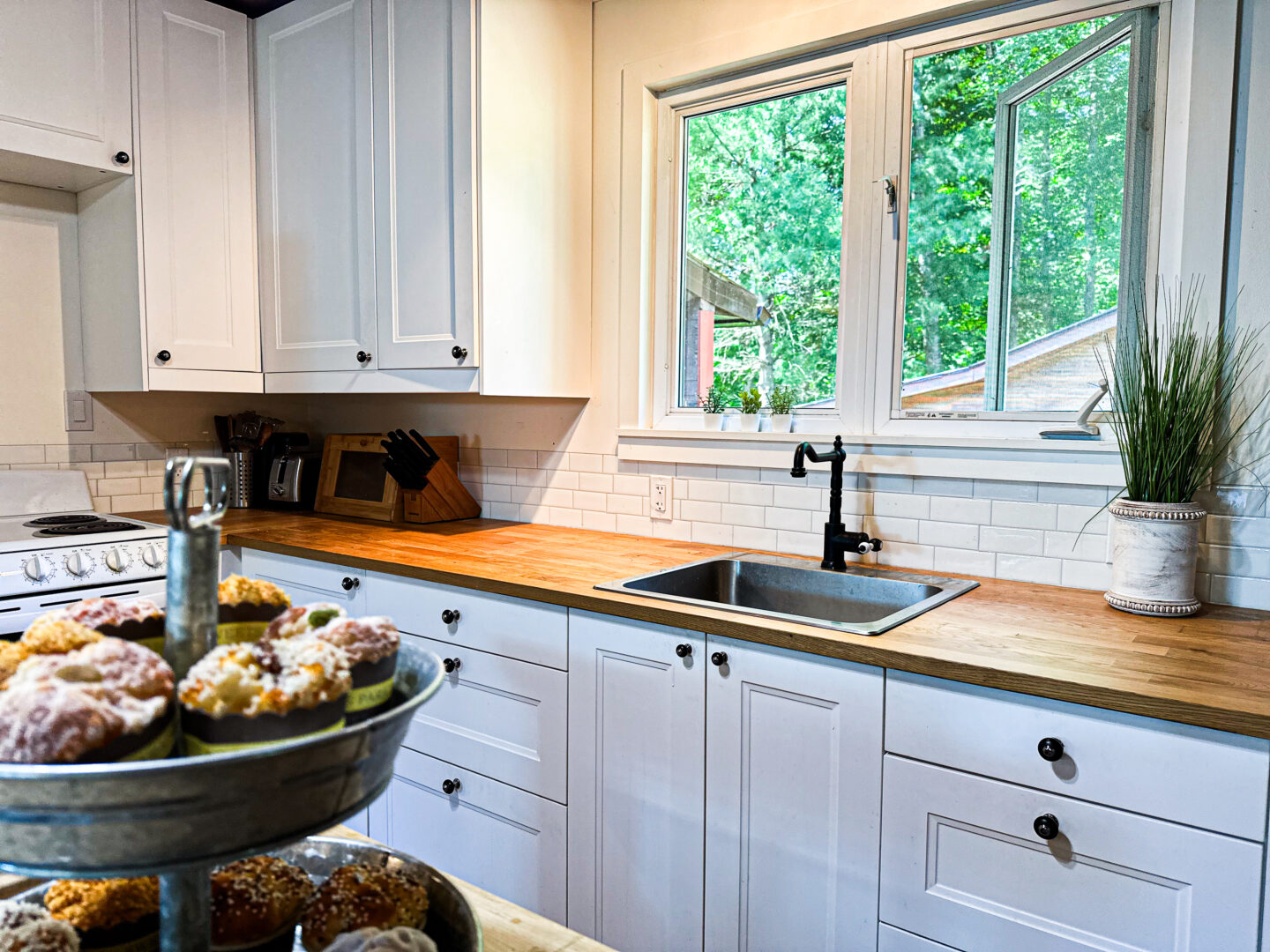 A white kitchen with wood countertops