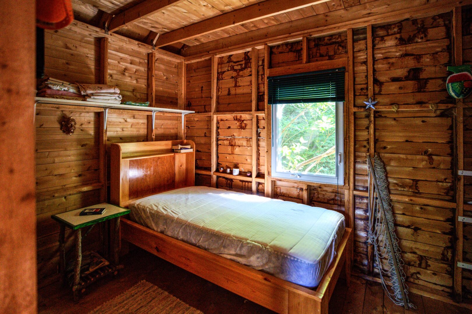 A bare mattress in a wood bedroom