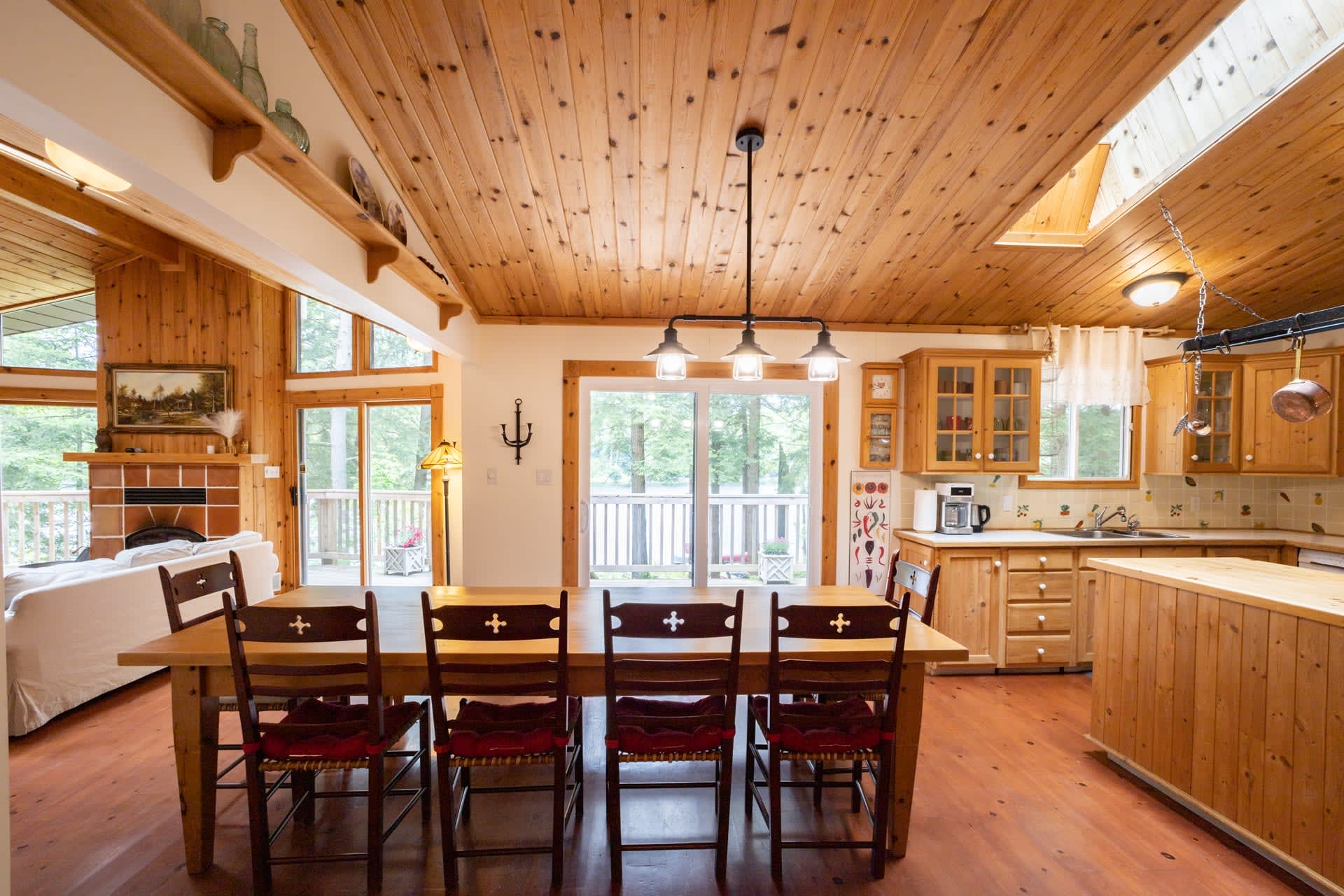 A long dining table in a wood paneled room