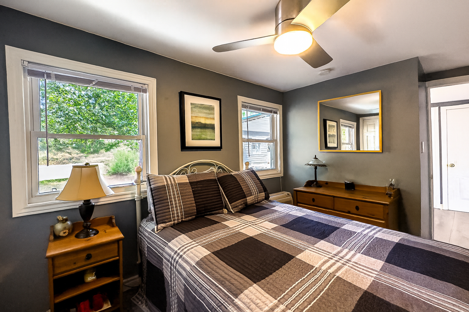 A black and white gingham bed in a grey room