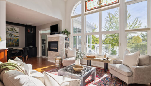 A spacious living area with cathedral windows and a white sitting area