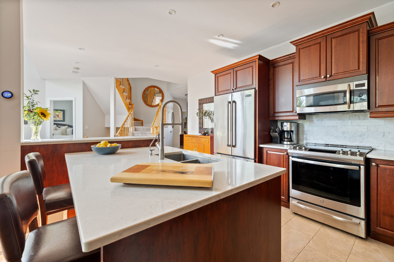 A white dark brown kitchen with white countertops
